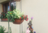 stojaki z kwiatami przy wejściu do domu, zmieniają się w zależności od pory roku