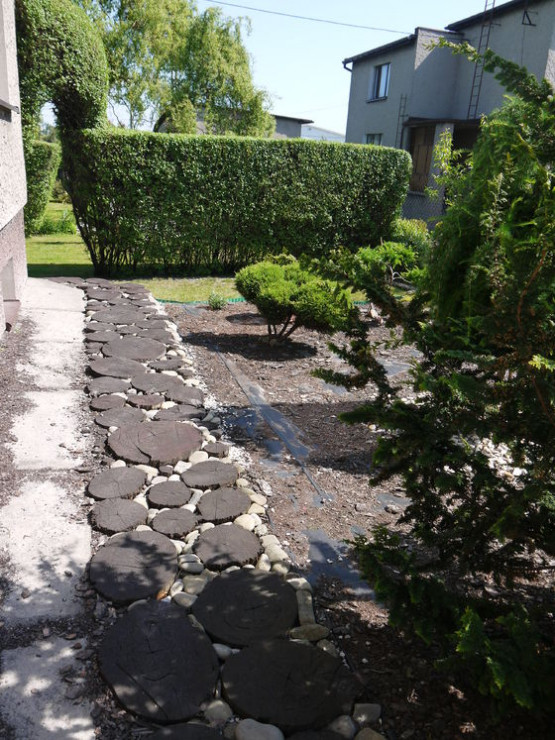 Ścieżka z bali w ziemi w ogrodzie japońskim.